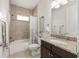 Well-lit bathroom with a shower-tub combo, granite counters, and tile floors at 4360 Sw 62Nd Loop, Ocala, FL 34474