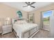 Bedroom features neutral colors, a silver bed frame, and natural light from the window at 4360 Sw 62Nd Loop, Ocala, FL 34474