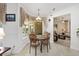 Dining area with a marble table and chairs, connecting to the kitchen and the living room area at 4360 Sw 62Nd Loop, Ocala, FL 34474