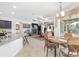 Dining area with a table set for four, connecting to the kitchen and offering views of the pool at 4360 Sw 62Nd Loop, Ocala, FL 34474