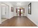 An empty dining room with hardwood floors, chandelier, and a window for natural light at 4360 Sw 62Nd Loop, Ocala, FL 34474