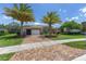 Charming single-story home with lush landscaping, paver driveway, and mature palm trees creating curb appeal at 4360 Sw 62Nd Loop, Ocala, FL 34474