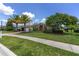 Beautifully landscaped front yard featuring a well-manicured lawn and mature flowering tree at 4360 Sw 62Nd Loop, Ocala, FL 34474