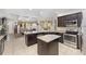 Open kitchen featuring stainless steel appliances, a granite countertop island, and dark wood cabinetry at 4360 Sw 62Nd Loop, Ocala, FL 34474