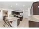 Kitchen featuring granite countertops, dark wood cabinets, and stainless steel appliances in an open space at 4360 Sw 62Nd Loop, Ocala, FL 34474
