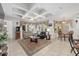 Bright living room featuring a decorative ceiling, tan tile floors, a ceiling fan, and large windows with custom valances at 4360 Sw 62Nd Loop, Ocala, FL 34474