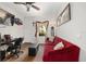 Inviting living room features a red couch, dark floors, and natural light from the window at 4360 Sw 62Nd Loop, Ocala, FL 34474