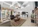 Open floor plan living room with coffered ceilings, tile floors, and easy access to the modern kitchen and dining area at 4360 Sw 62Nd Loop, Ocala, FL 34474