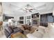 Open concept living room with a stone fireplace, built-ins, tile floors, and a view of the kitchen and dining spaces at 4360 Sw 62Nd Loop, Ocala, FL 34474