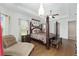 Spacious main bedroom boasts a tray ceiling, four-poster bed, and natural light at 4360 Sw 62Nd Loop, Ocala, FL 34474
