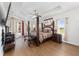 Bright main bedroom features a four-poster bed, tray ceilings, and a view to the pool at 4360 Sw 62Nd Loop, Ocala, FL 34474