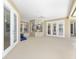 Open patio with multiple entry points featuring tile floors, a ceiling fan, and beautiful natural light at 4360 Sw 62Nd Loop, Ocala, FL 34474