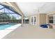Covered patio area with a full screen, a swimming pool, and a jacuzzi at 4360 Sw 62Nd Loop, Ocala, FL 34474