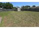 Large backyard featuring a storage shed, framed by a wooden fence, offering a blend of utility and outdoor space at 5130 Se 106 Lane, Belleview, FL 34420