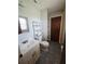Compact bathroom features tiled floors, modern vanity, and built-in shelving for storage at 5130 Se 106 Lane, Belleview, FL 34420