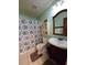 Charming bathroom with patterned shower curtain, traditional vanity, and ample natural light at 5130 Se 106 Lane, Belleview, FL 34420