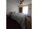 Relaxing bedroom with soft lighting, patterned bedspread, and window views for natural light at 5130 Se 106 Lane, Belleview, FL 34420