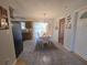 Bright dining area adjacent to kitchen with tile floors, stylish lighting, and views of the backyard through sheer curtains at 5130 Se 106 Lane, Belleview, FL 34420