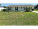 Inviting single-Gathering home with a well-kept lawn and a charming front entrance, complete with flowerbed and dark shutters at 5130 Se 106 Lane, Belleview, FL 34420