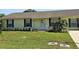 Well-maintained single-story home showcases a neat lawn and inviting front entrance; manicured bushes add to its curb appeal at 5130 Se 106 Lane, Belleview, FL 34420