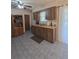Traditional kitchen with wood cabinets, tile flooring, and a ceiling fan for added comfort at 5130 Se 106 Lane, Belleview, FL 34420