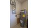 Utility room featuring a Rheem water heater and Massey electric panel for efficient home systems at 5130 Se 106 Lane, Belleview, FL 34420
