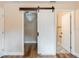 Bathroom featuring a sliding barn door and a partial view of the shower at 5193 Nw 61St Ave, Ocala, FL 34482