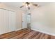Bedroom with wood-look floors leading to a hallway and bi-fold closet doors at 5193 Nw 61St Ave, Ocala, FL 34482