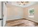 Bright bedroom with tray ceiling, ceiling fan, and wood-look flooring at 5193 Nw 61St Ave, Ocala, FL 34482