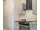 Close-up on a stainless steel oven, wooden counter tops, and modern range hood at 5193 Nw 61St Ave, Ocala, FL 34482