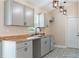 Stylish kitchen featuring gray cabinets, butcher block counters, and modern light fixtures at 5193 Nw 61St Ave, Ocala, FL 34482