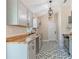 Well-lit kitchen featuring wood countertops, modern tile flooring, and sleek appliances at 5193 Nw 61St Ave, Ocala, FL 34482