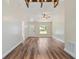 Well-lit living room with new hard floors and a contemporary ceiling fan, creating a welcoming atmosphere at 5193 Nw 61St Ave, Ocala, FL 34482