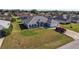 Aerial shot of a single-story house with a well-kept lawn and driveway, complete with a parked red truck at 5920 Sw 88Th Pl, Ocala, FL 34476