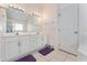 This bathroom features a large vanity with dual sinks, and white tiled floors at 5920 Sw 88Th Pl, Ocala, FL 34476