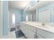 This bathroom features a large vanity with dual sinks and white tiled floors at 5920 Sw 88Th Pl, Ocala, FL 34476
