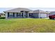 Charming single-story home featuring a well-maintained lawn, grey exterior paint, and a two-car garage at 5920 Sw 88Th Pl, Ocala, FL 34476