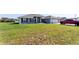 Blurred image of a single-story house with well-maintained lawn and spacious driveway and a red Tacoma at 5920 Sw 88Th Pl, Ocala, FL 34476