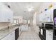 Bright kitchen features white cabinets, granite countertops, and stainless-steel appliances at 5920 Sw 88Th Pl, Ocala, FL 34476