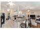 Efficient kitchen with a breakfast bar, granite countertops, white cabinets, and black appliances at 5920 Sw 88Th Pl, Ocala, FL 34476
