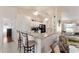 A modern eat-in kitchen with breakfast bar, granite countertops, white cabinets, and stainless steel appliances at 5920 Sw 88Th Pl, Ocala, FL 34476