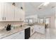 Bright kitchen features white cabinets, granite countertops, and stainless-steel appliances at 5920 Sw 88Th Pl, Ocala, FL 34476