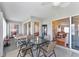 Enclosed lanai featuring a glass table and views of the interior of the home through large windows at 5920 Sw 88Th Pl, Ocala, FL 34476