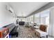The bright sunroom has comfortable seating and large windows offering plenty of natural light and neighborhood views at 5920 Sw 88Th Pl, Ocala, FL 34476