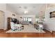 Spacious living room featuring vaulted ceilings, hardwood floors, neutral decor, and sliding glass doors at 5920 Sw 88Th Pl, Ocala, FL 34476