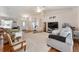 Comfortable living room with vaulted ceilings, an open floor plan, and a neutral color scheme creating a calming atmosphere at 5920 Sw 88Th Pl, Ocala, FL 34476