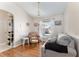 Inviting living room featuring hardwood floors, a cozy sofa, and plenty of natural light at 5920 Sw 88Th Pl, Ocala, FL 34476