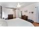 This main bedroom offers neutral walls, a ceiling fan and wood floors at 5920 Sw 88Th Pl, Ocala, FL 34476