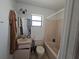 This well-lit bathroom has a tub, toilet, sink and vanity, and a window for natural light at 6 Bahia Trace Loop, Ocala, FL 34472
