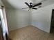 Bedroom featuring tile flooring, a ceiling fan, and a closet for storage at 6 Bahia Trace Loop, Ocala, FL 34472